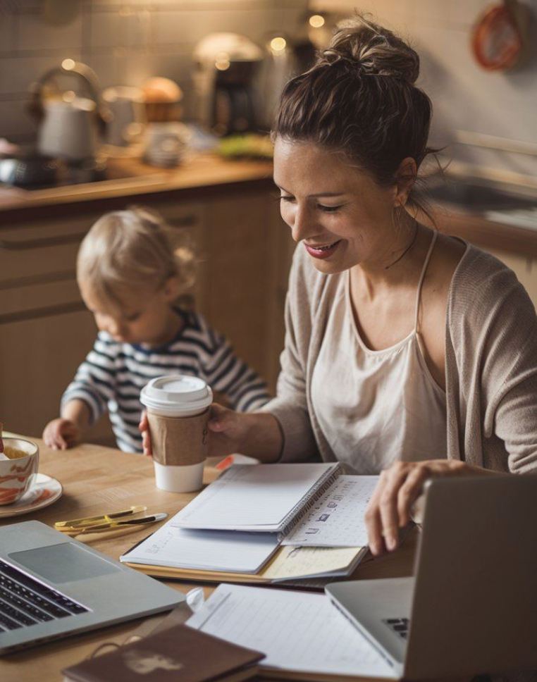 Maman en télétravail a côté de son jeune enfant 