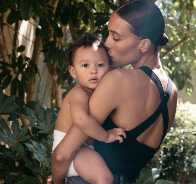 A mother tenderly holding her baby 