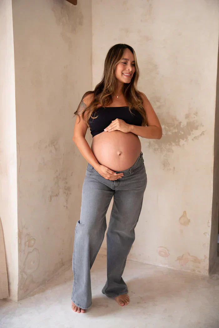 Pregnant woman wearing gray maternity jeans 
