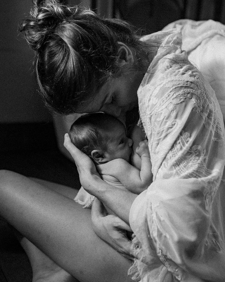 a mother hugging her baby 